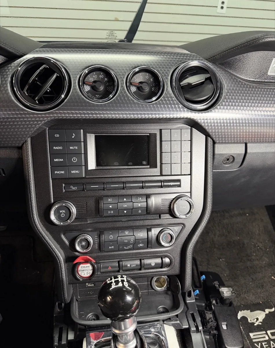 Mustang dash with the factory head unit still in place