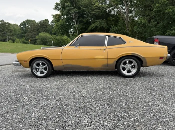 Gold classic Ford Maverick with tinted windows