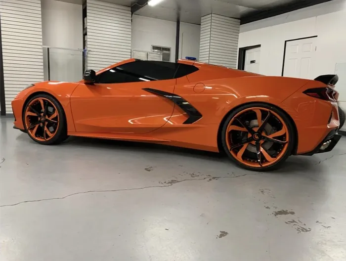 Orange Chevrolet Corvette C8 with tinted glass, side profile