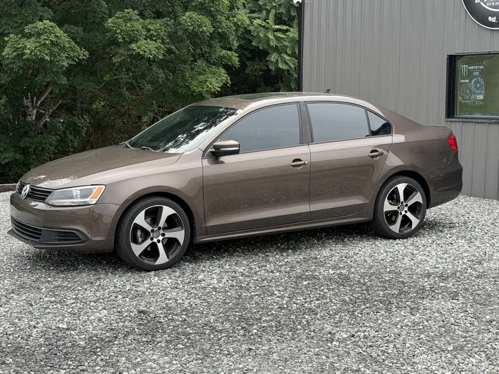 Brown Volkswagen Jetta with tinted windows, side view