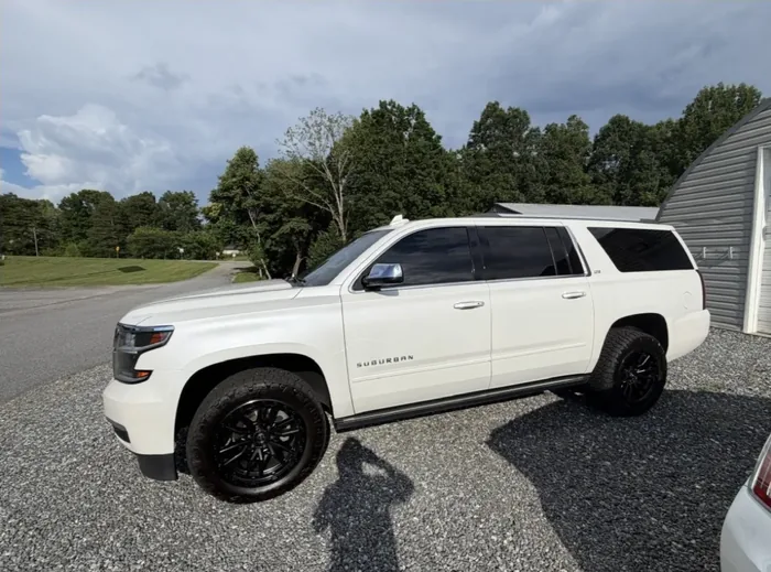 White Chevrolet Suburban with tinted windows
