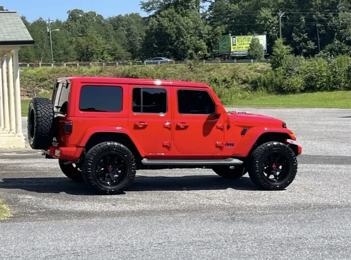 Red Jeep Wrangler with tinted windows
