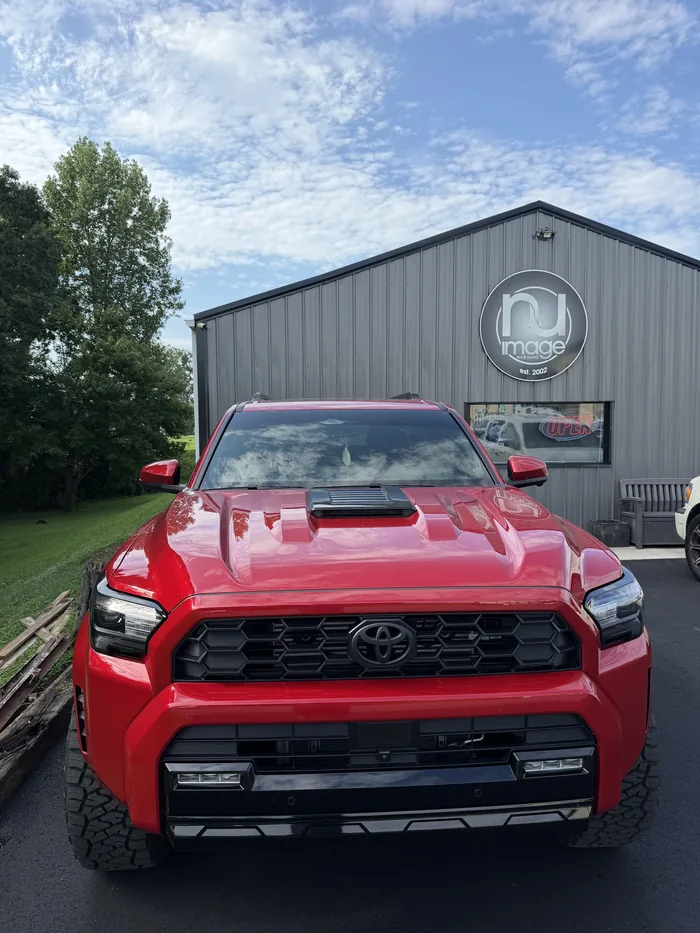 Red Toyota 4Runner photographed head-on outside the NU-Image shop